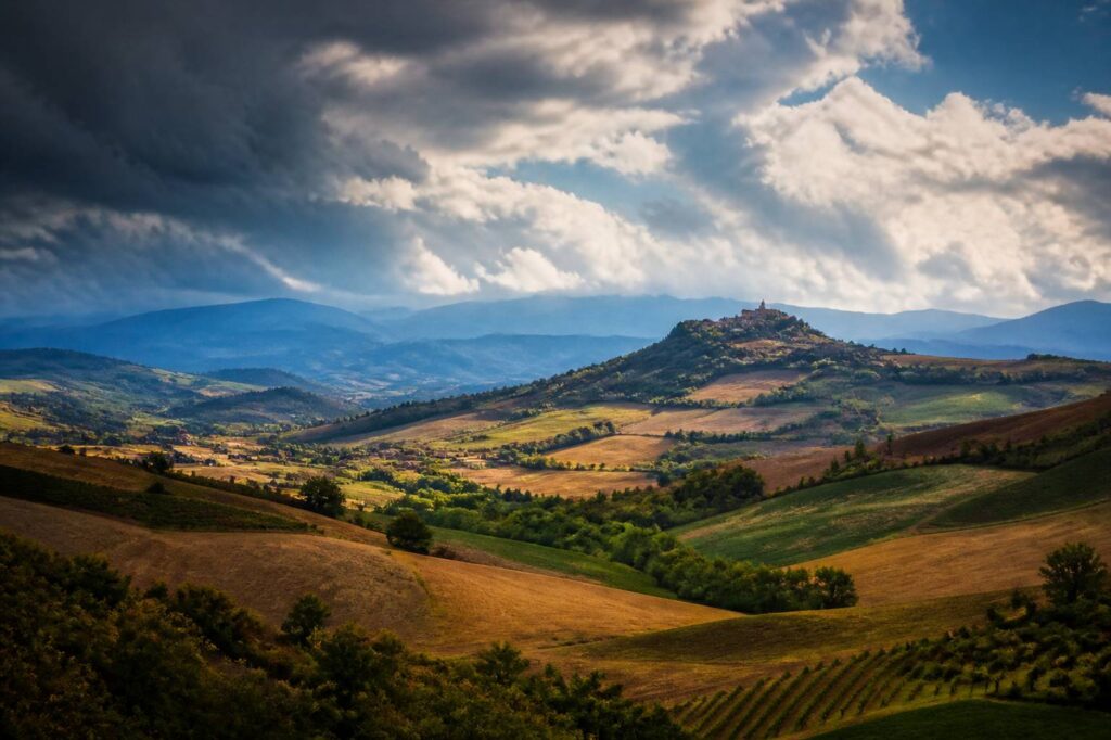 Collines des Marches sous un ciel mêlant soleil et nuages d'orage